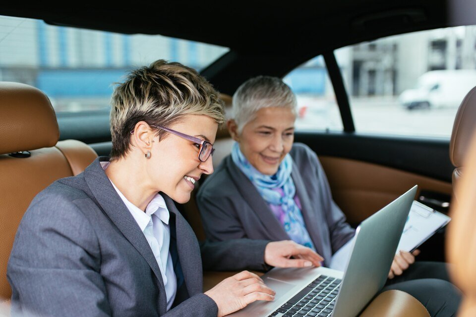 Working women in car on a Long Distance Chauffeur Service
