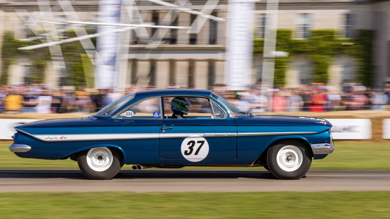 Classic blue Chevrolet Impala racing car on track at a UK motorsport event