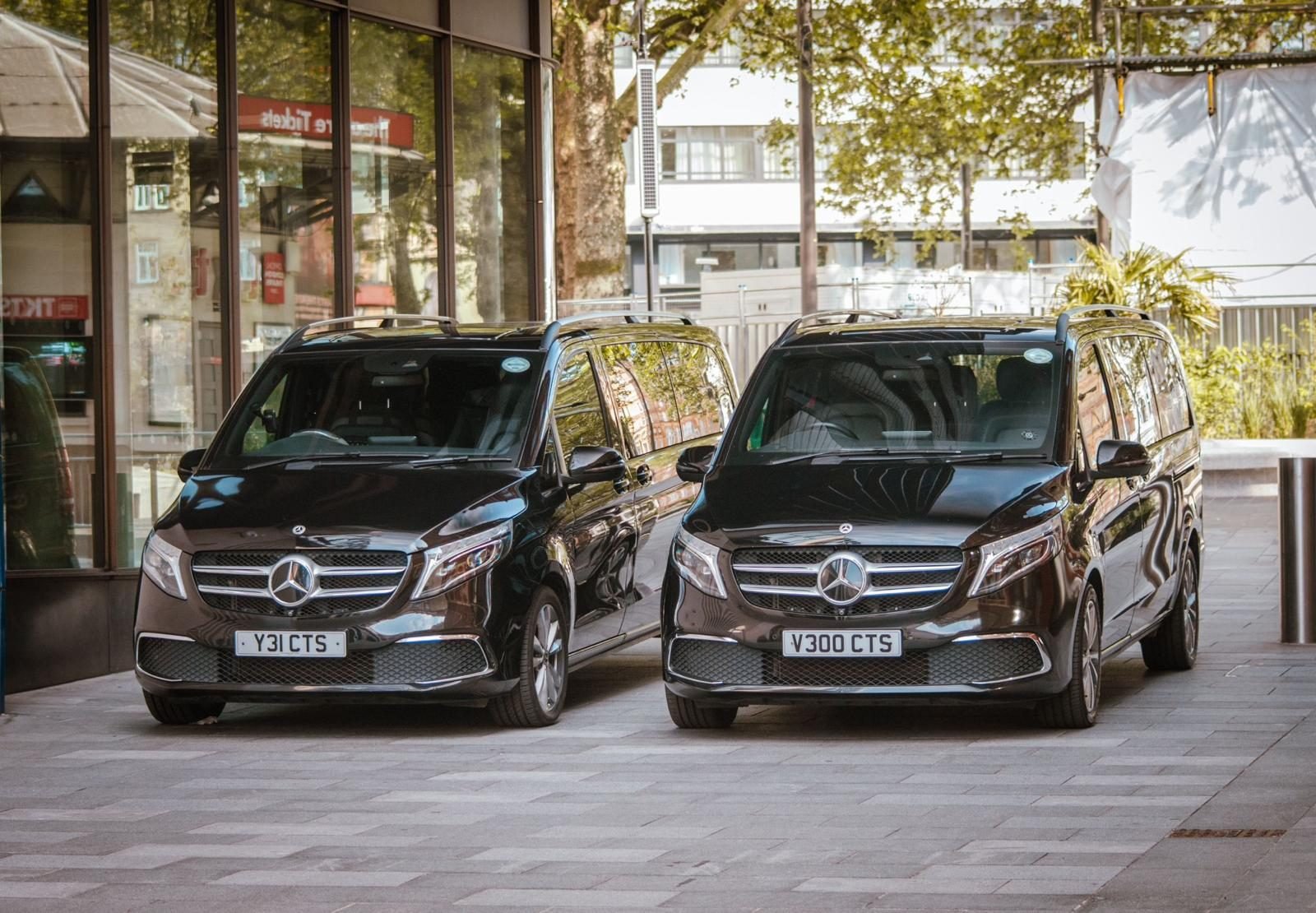 Two black Mercedes-Benz V-Class chauffeur cars waiting at Leicester Square in London