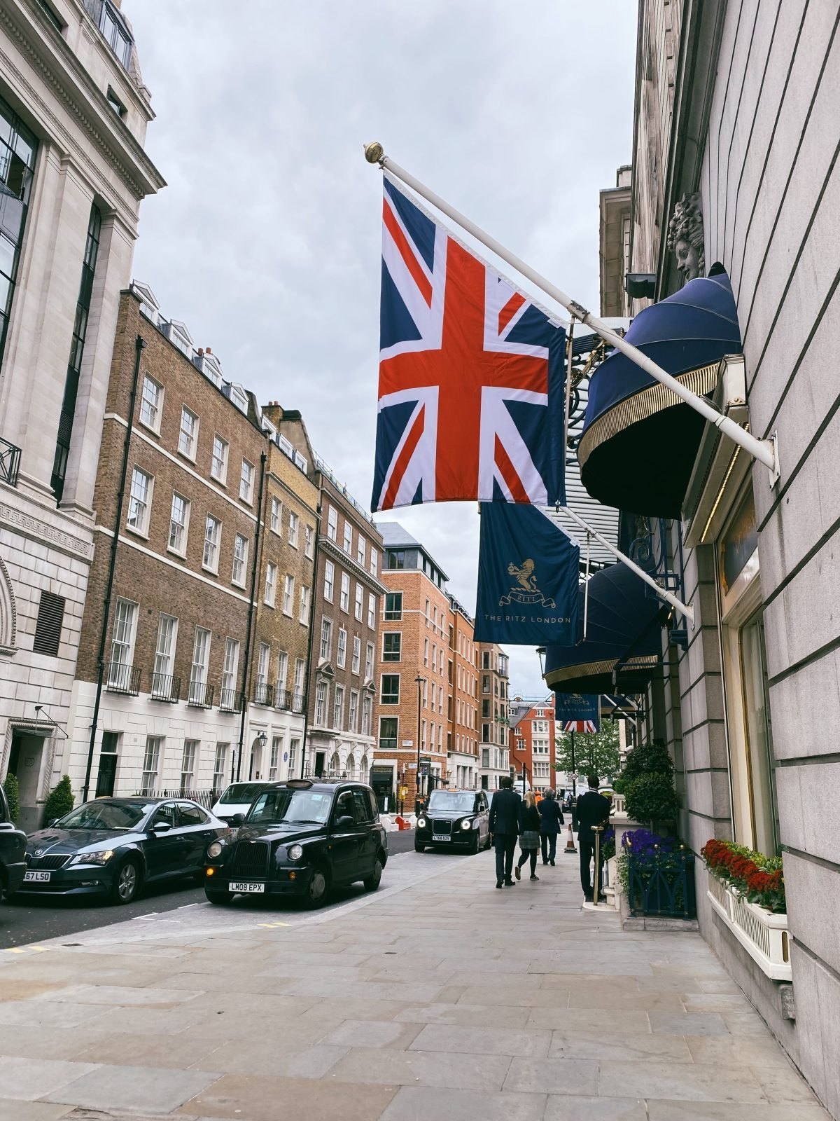 Union flag and The Ritz London banner above the hotel entrance on Arlington Street